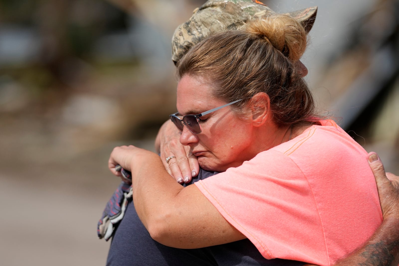 Tammy Bryan hugs fellow resident Mark Johnson amid the destruction in the aftermath of Hurricane Helene, in Horseshoe Beach, Fla., Saturday, Sept. 28, 2024. (AP Photo/Gerald Herbert)