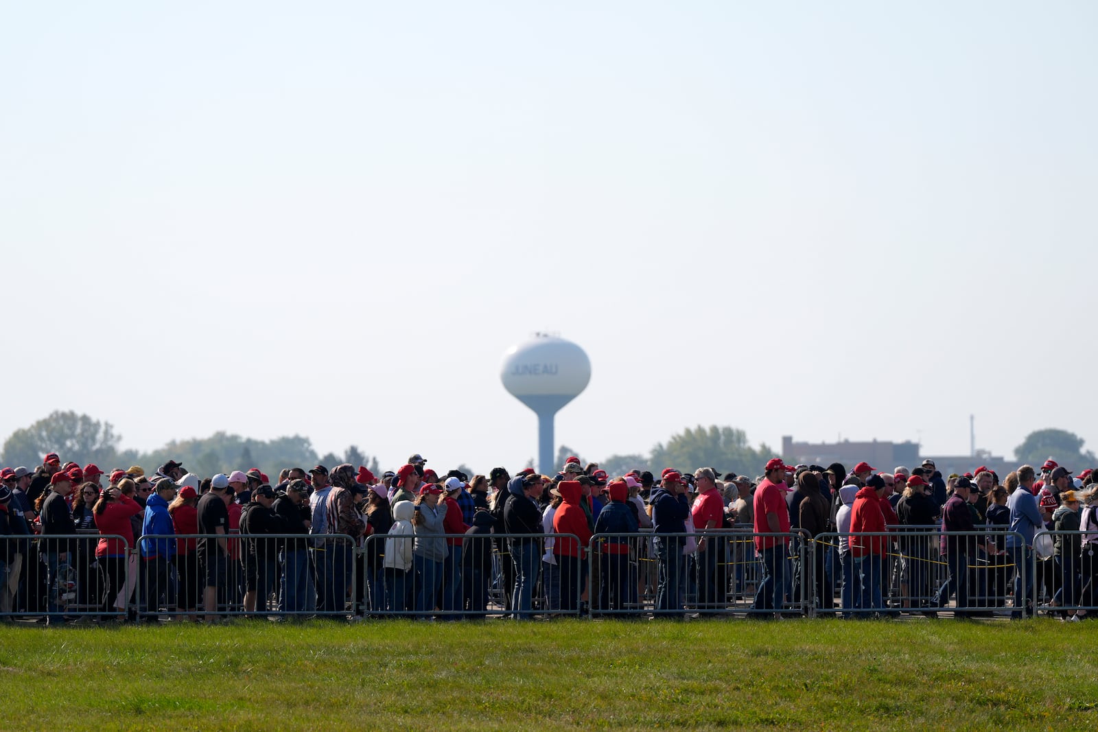 Attendees wait in line before a campaign rally for Republican presidential nominee former President Donald Trump at Dodge County Airport, Sunday, Oct. 6, 2024, in Juneau, Wis. (AP Photo/Julia Demaree Nikhinson)