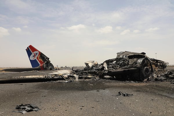 Yemenis inspect wreckage of a destroyed civilian aircraft following Israeli airstrikes on Sanaa International Airport in Sanaa, Yemen, Wednesday, May 7, 2025. (AP Photo/Osamah Abdulrahman)