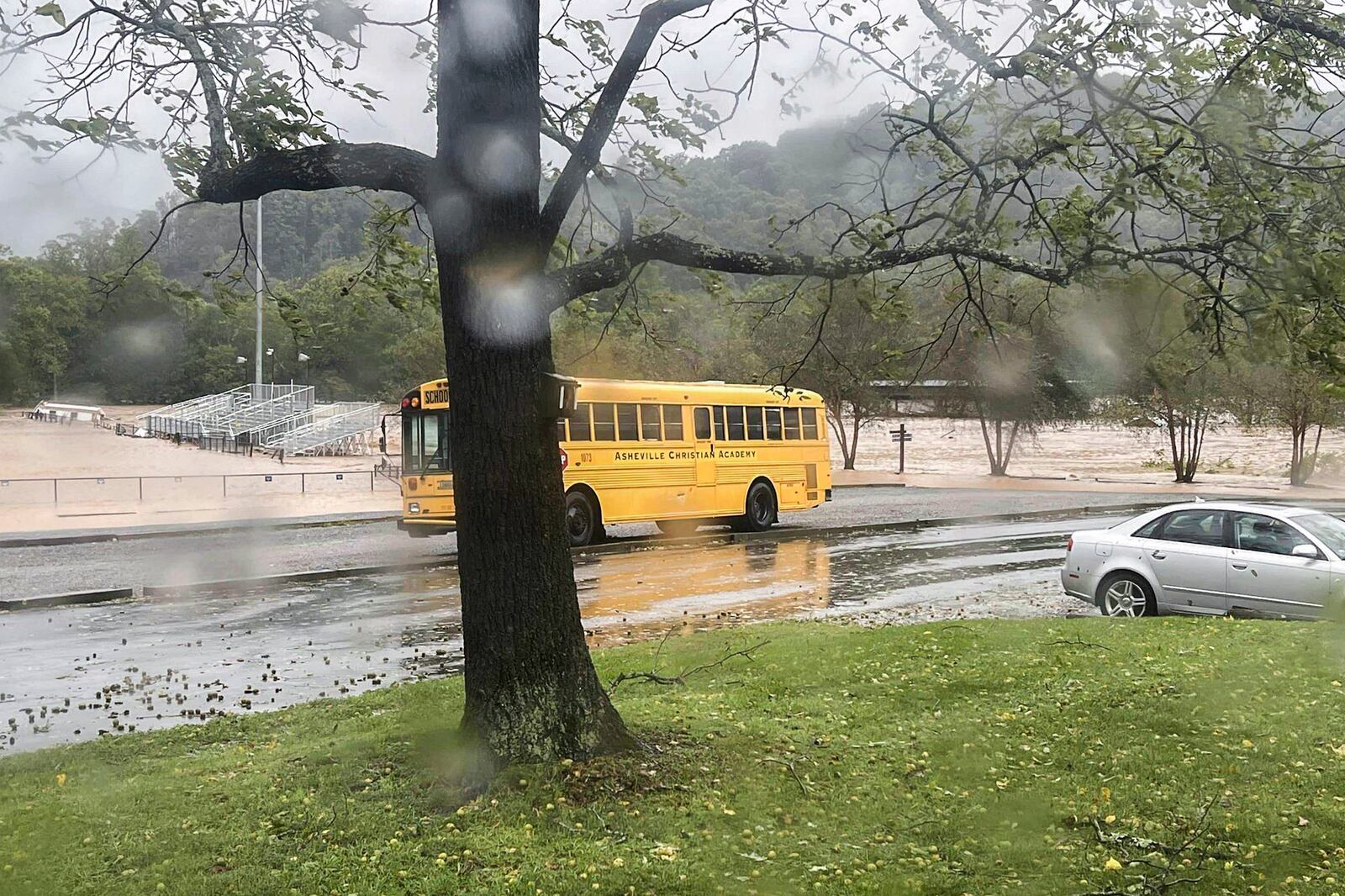 This photo provided by Kelly Benware shows flooding around the football field at Asheville Christian Academy in Swannanoa, N.C., on Friday, Sept. 27, 2024. (Kelly Benware via AP)