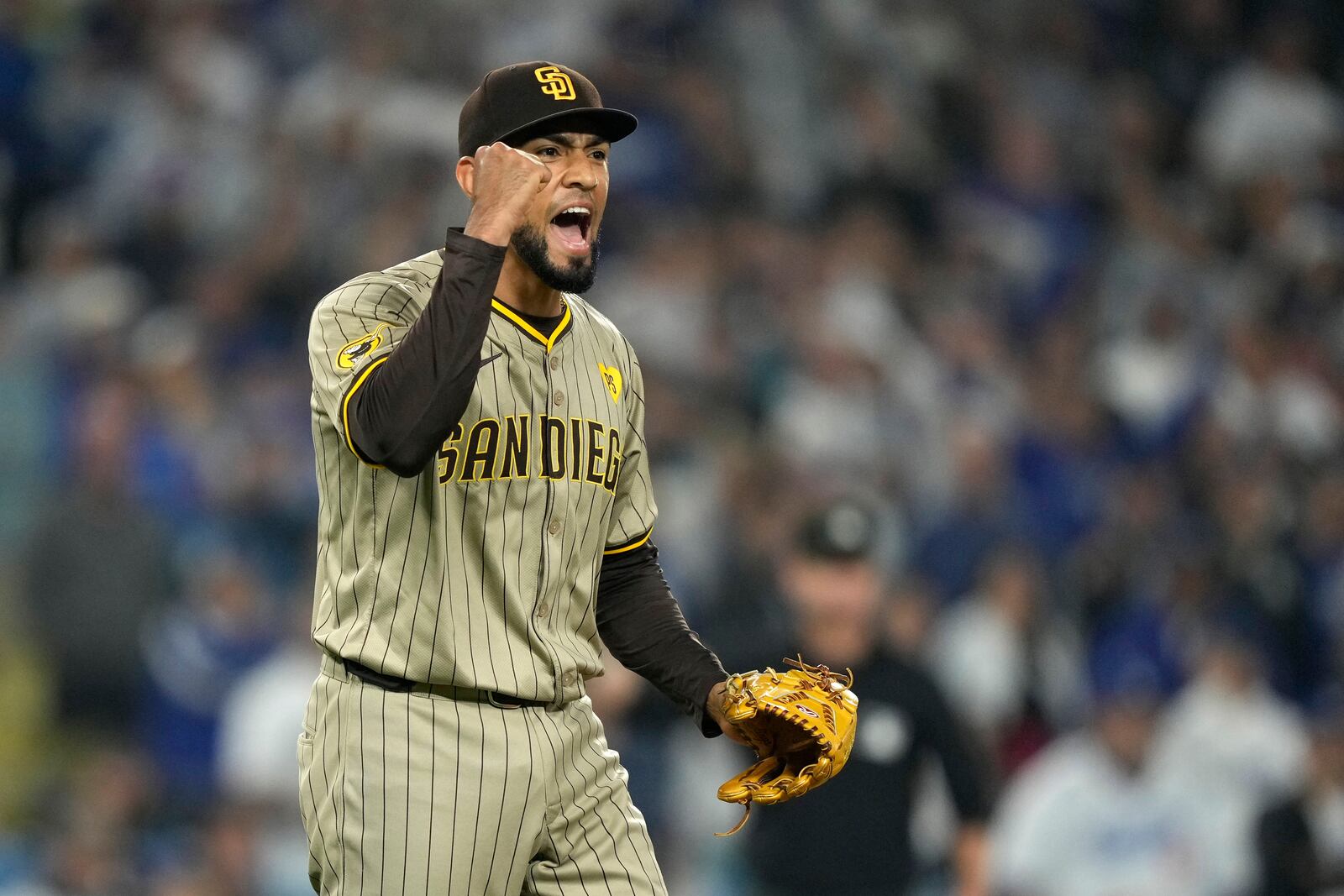 San Diego Padres relief pitcher Robert Suarez celebrates after the Padres clinched a playoff spot with a triple play to end their baseball game against the Los Angeles Dodgers, Tuesday, Sept. 24, 2024, in Los Angeles. (AP Photo/Mark J. Terrill)