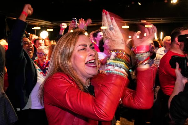 Labor Party supporters react as they watch results shown on a screen at their party headquarters in Sydney, Saturday, May 3, 2025. (AP Photo/Rick Rycroft)