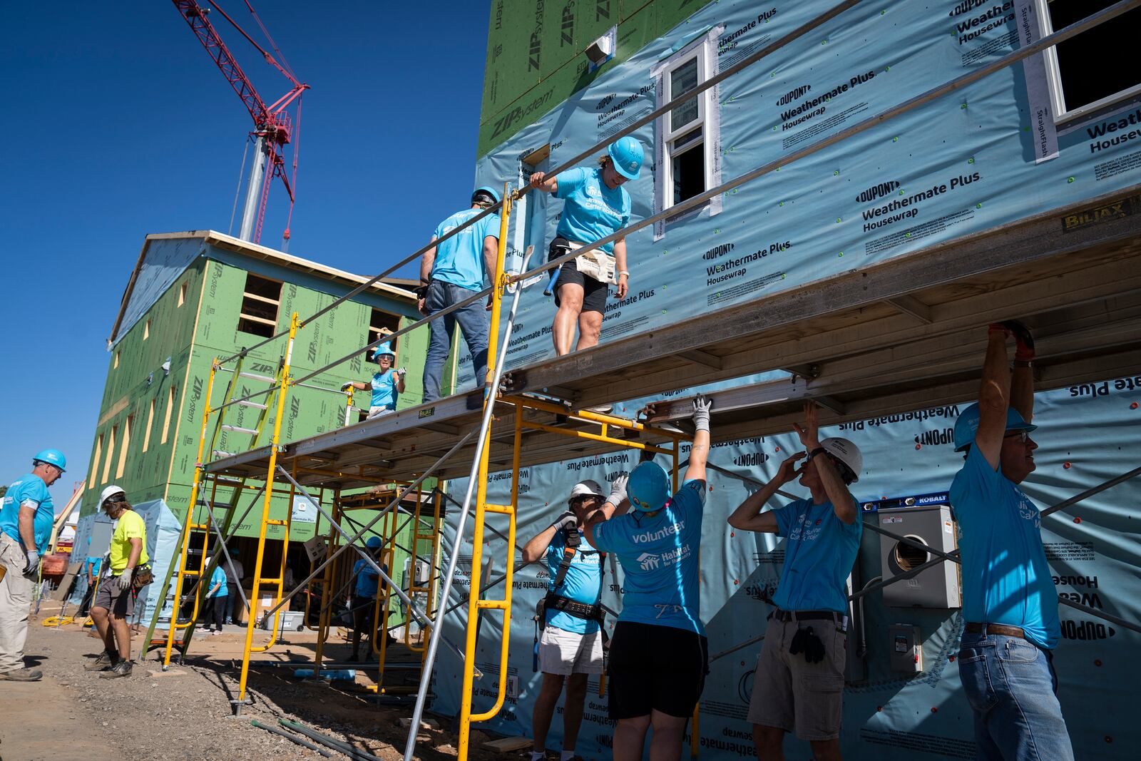 Volunteers build houses during Twin Cities Habitat for Humanity's 2024 Jimmy & Rosalynn Carter Work Project at the site of the former Hillcrest Golf Course in St. Paul, Minn. on Monday, Sept. 30, 2024. (Leila Navidi /Star Tribune via AP)