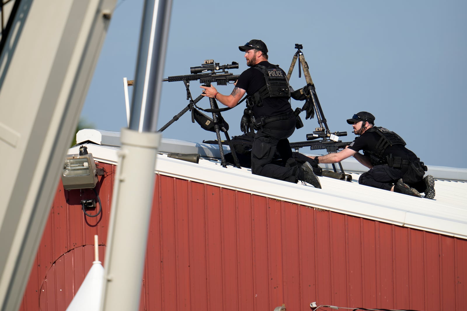 FILE - Police snipers return fire after shots were fired while Republican presidential candidate former President Donald Trump was speaking at a campaign event in Butler, Pa., July 13, 2024. (AP Photo/Gene J. Puskar, File)