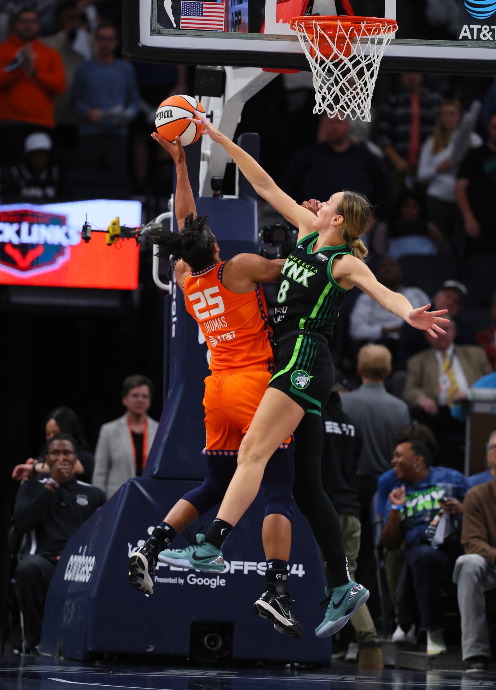 Connecticut Sun forward Alyssa Thomas (25) shoots while Minnesota Lynx forward Alanna Smith (8) defends during the second half of Game 2 of a WNBA basketball semifinals game, Tuesday, Oct. 1, 2024, in Minneapolis. (AP Photo/Adam Bettcher)