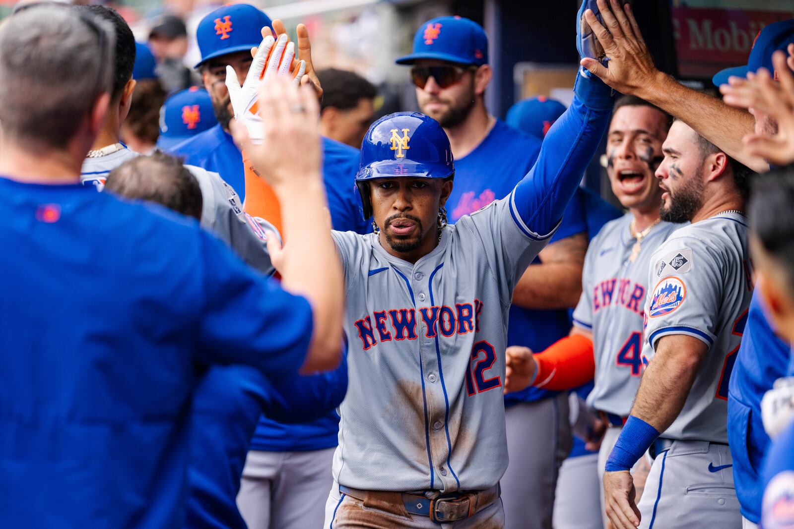 New York Mets' Francisco Lindor celebrates in the dugout after scoring in the eighth inning of a baseball game against the Atlanta Braves, Monday, Sept. 30, 2024, in Atlanta. (AP Photo/Jason Allen)