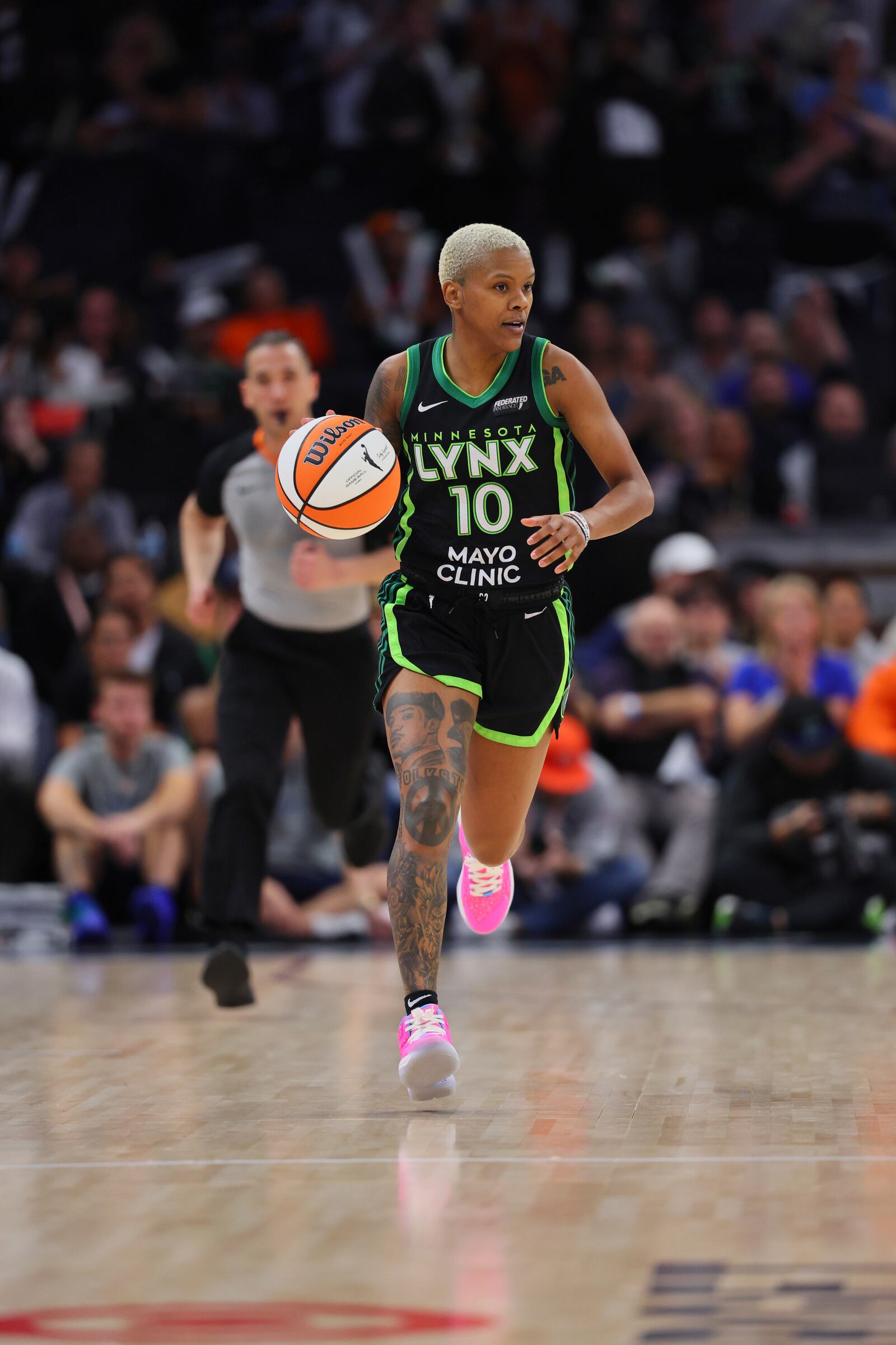 Minnesota Lynx guard Courtney Williams (10) brings the ball up the court during the second half of Game 2 of a WNBA basketball semifinals game against the Connecticut Sun, Tuesday, Oct. 1, 2024, in Minneapolis. (AP Photo/Adam Bettcher)