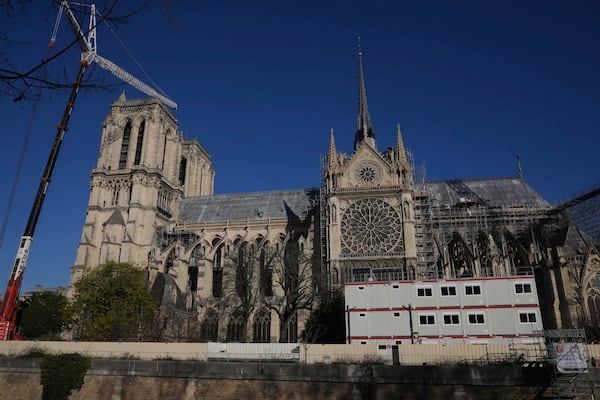 Cranes and workers' facilities are seen along Notre-Dame cathedral, Thursday, Nov. 28, 2024 in Paris. (AP Photo/Michel Euler)