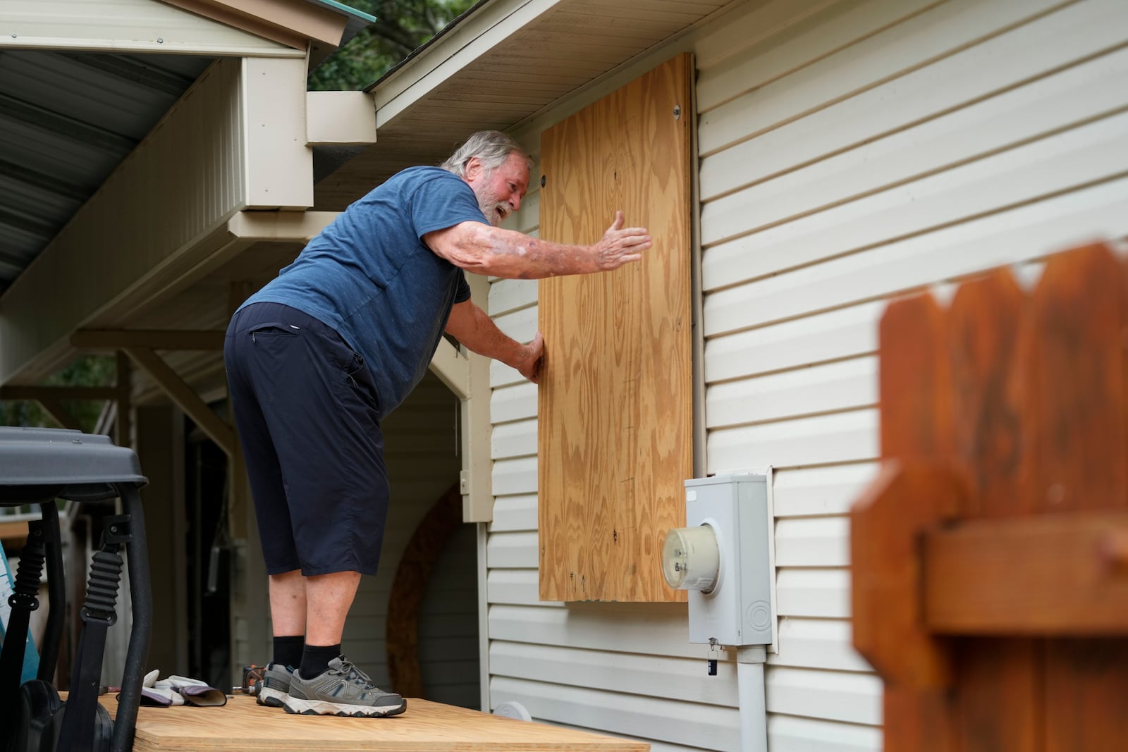 Dave McCurley boards up the windows to his home in advance of Tropical Storm Helene, expected to make landfall as a hurricane, in Ochlockonee Bay, Fla., Wednesday, Sept. 25, 2024. (AP Photo/Gerald Herbert)