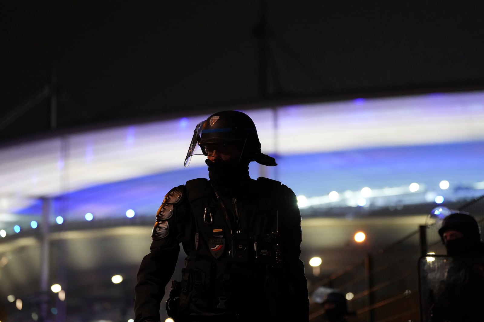 A riot police officer stands outside the Stade de France stadium ahead of the Nations League soccer match France against Israel , Thursday, Nov. 14, 2024 in Saint-Denis, outside Paris. (AP Photo/Aurelien Morissard)