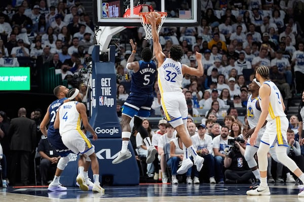Minnesota Timberwolves guard Anthony Edwards (5) goes up for a shot as Golden State Warriors forward Trayce Jackson-Davis (32) defends during the first half of Game 2 of an NBA basketball second-round playoff series, Thursday, May 8, 2025, in Minneapolis. (AP Photo/Abbie Parr)