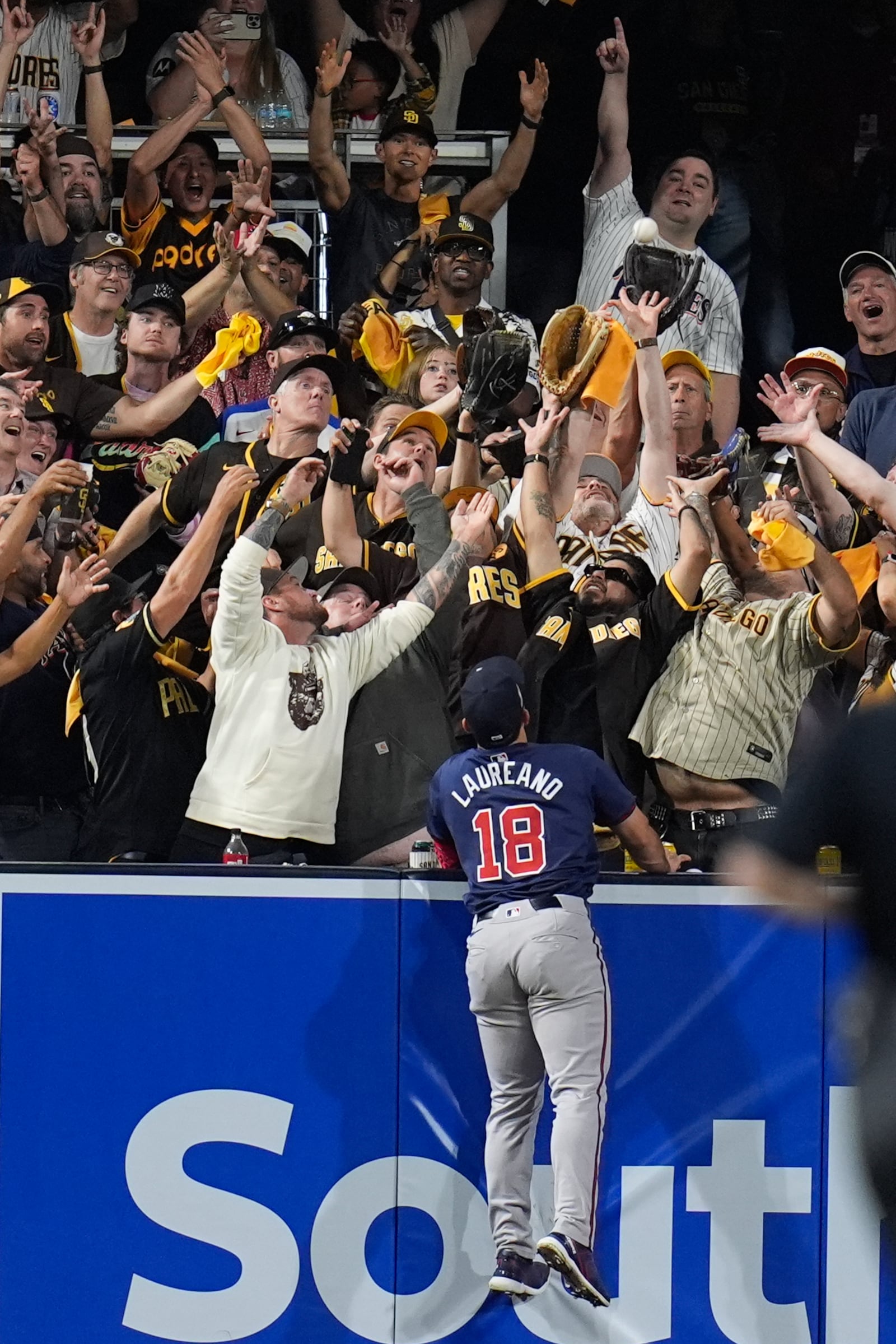 Atlanta Braves left fielder Ramón Laureano watches a home run from San Diego Padres' Kyle Higashioka go over the wall during the eighth inning in Game 1 of an NL Wild Card Series baseball game Tuesday, Oct. 1, 2024, in San Diego. (AP Photo/Gregory Bull)