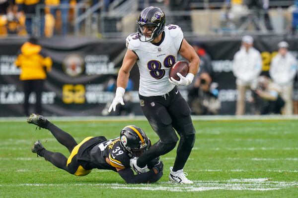 Baltimore Ravens tight end Mark Andrews (89) runs with the ball as Pittsburgh Steelers safety Minkah Fitzpatrick tries to stop him during the second half of an NFL football game, Sunday, Nov. 17, 2024, in Pittsburgh. (AP Photo/Matt Freed)