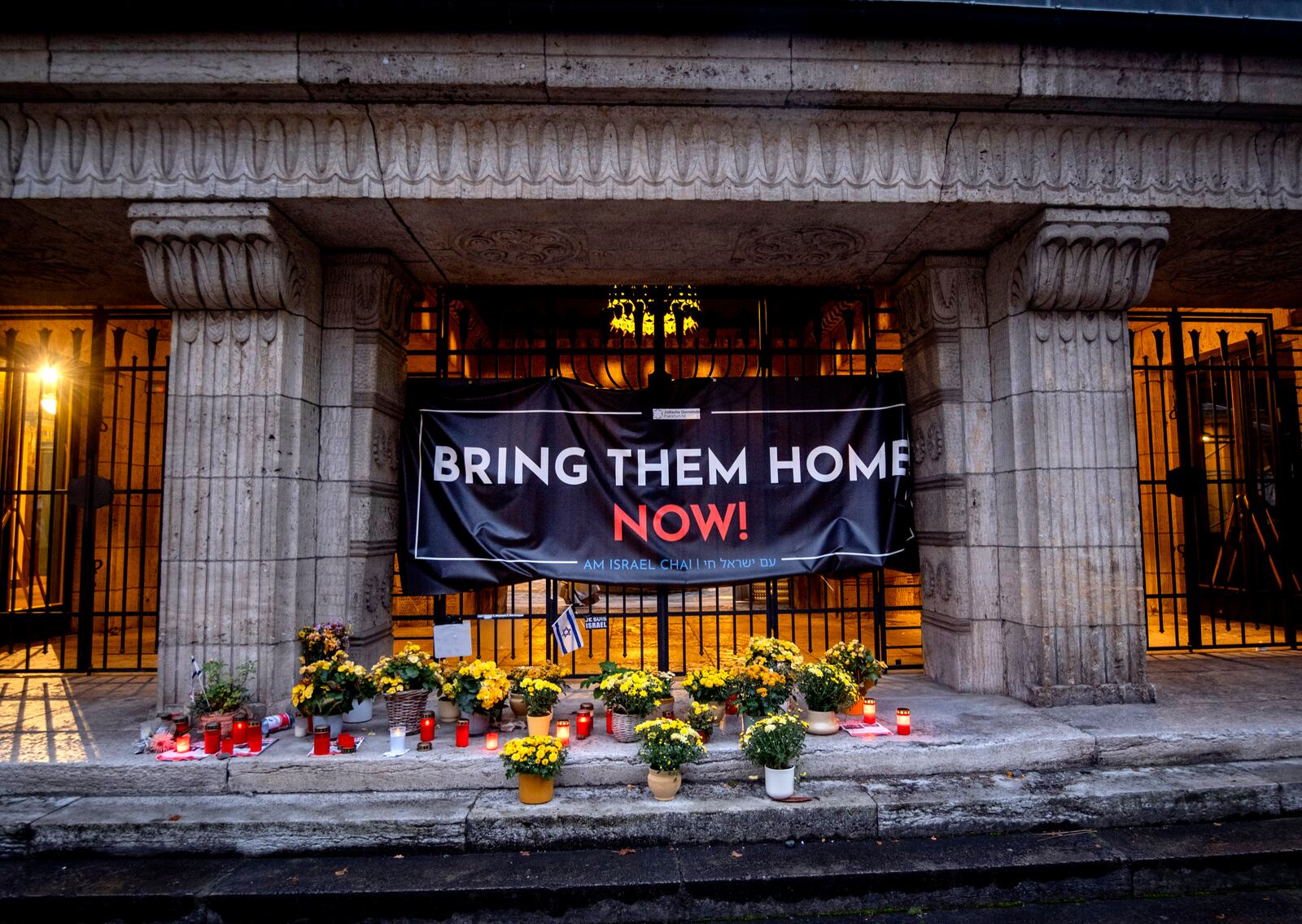 Candles and flowers are laid at the entrance of the synagogue to mark the first anniversary of the Hamas attack on Israel, Frankfurt, Germany, Monday, Oct. 7, 2024. (AP Photo/Michael Probst)