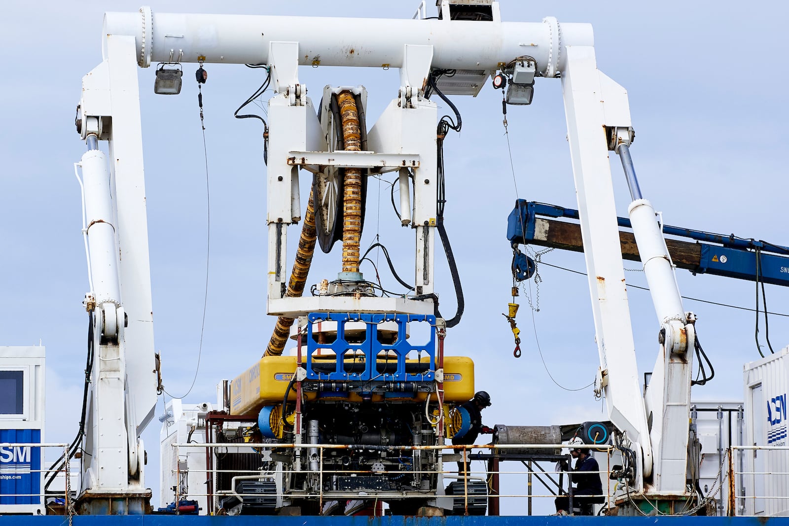 Workers on the vessel Nautilus that helped bury the subsea cables that run along the ocean floor to connect the wave energy test site to facilities on land near Newport, Ore., Friday, Aug. 23, 2024. (AP Photo/Craig Mitchelldyer)