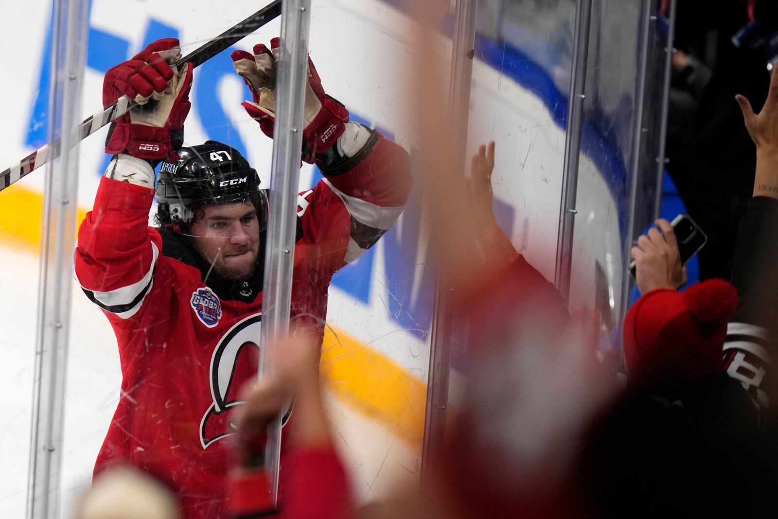 New Jersey Devils' Paul Cotter celebrates after scoring his sides second goal during the NHL hockey game between Buffalo Sabres and New Jersey Devils, in Prague, Czech Republic, Saturday, Oct. 5, 2024. (AP Photo/Petr David Josek)