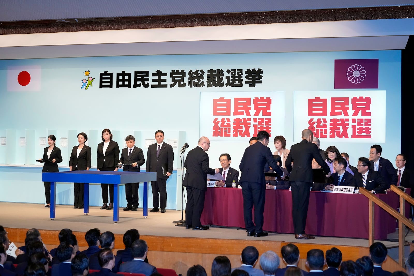 Officials show the result of the first voting to Election Commission during the Liberal Democratic Party's (LDP) leadership election at the party headquarters Friday, Sept. 27, 2024, in Tokyo. (AP Photo/Hiro Komae, Pool)