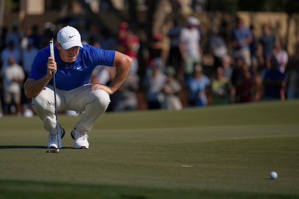 Rory McIlroy of Northern Ireland lines up a putt on the 8th green in the final round of World Tour Golf Championship in Dubai, United Arab Emirates, Sunday, Nov. 17, 2024. (AP Photo/Altaf Qadri)