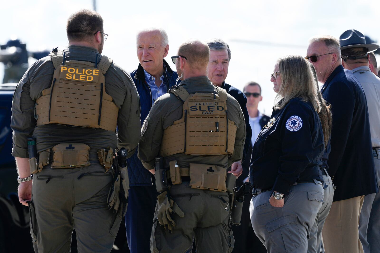 President Joe Biden and Gov. Roy Cooper, D-N.C., greet first responders after touring areas impacted by Hurricane Helene, at the ariport in Greenville, S.C., Wednesday, Oct. 2, 2024. (AP Photo/Susan Walsh)