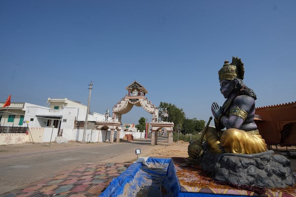 A statue of Monkey God Hanuman, installed as part of a religious celebrations, is seen in front of an entrance gate of Dingucha village in Gandhinagar, India, Tuesday, Nov. 12, 2024. (AP Photo/Ajit Solanki)