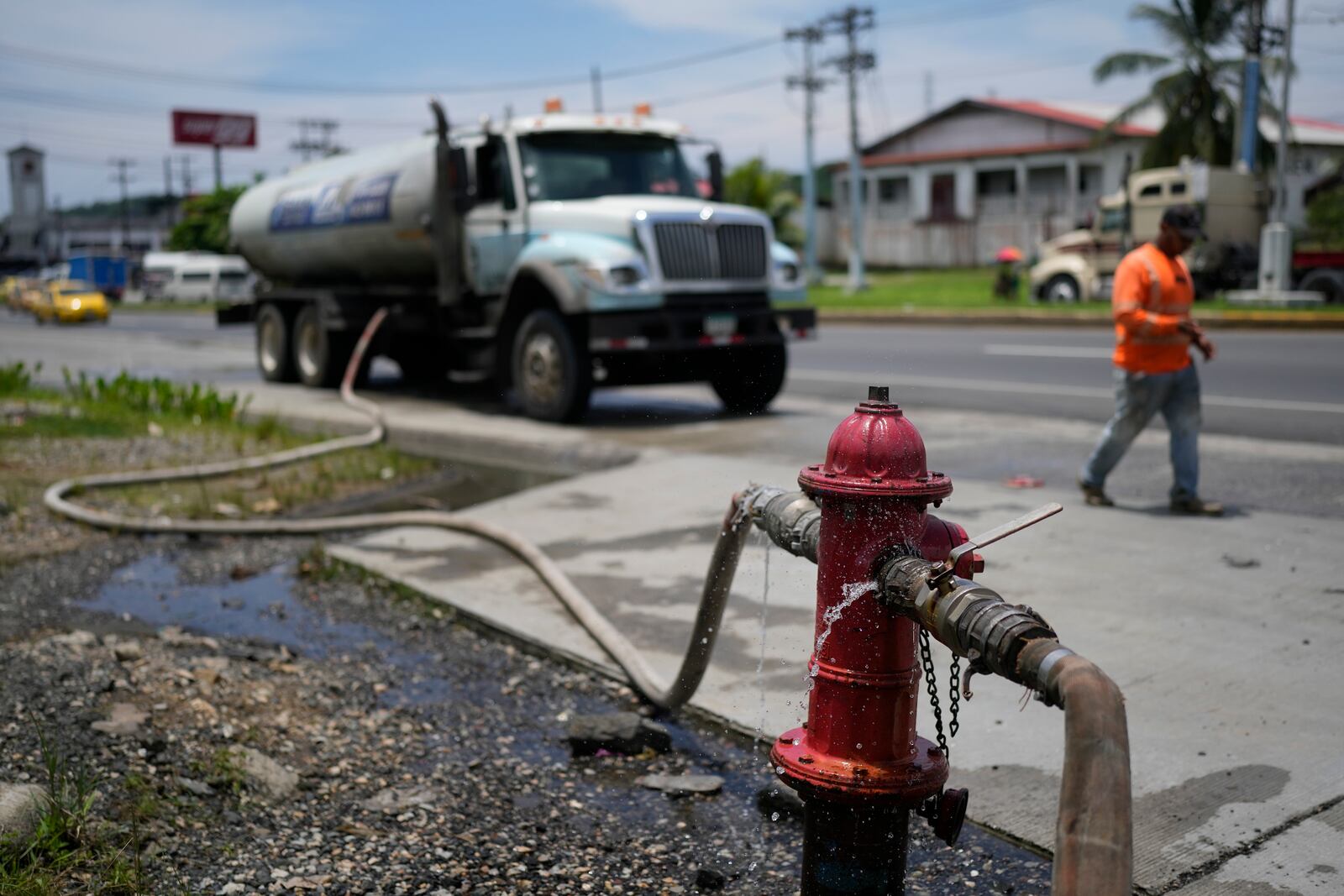 A water truck fills up at a fire hydrant to distribute to buildings in Colon, Panama, Monday, Sept. 2, 2024. In a proposed plan to dam the nearby Indio River and secure the Panama Canal's uninterrupted operation, the community would gain more reliable access to water. (AP Photo/Matias Delacroix)