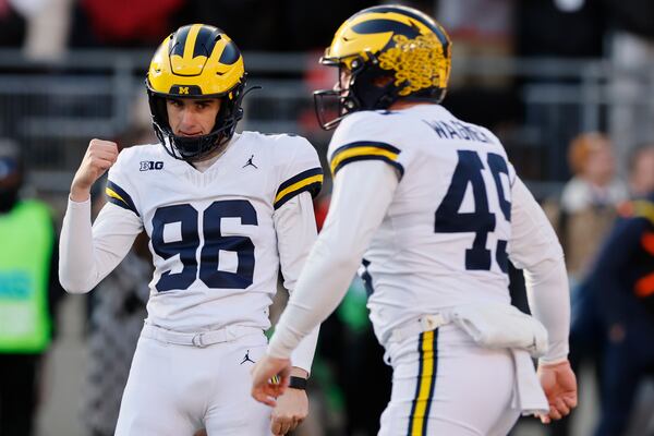 Michigan kicker Dominic Zvada, left, celebrates making the game-winning field goal against Ohio State during the second half of an NCAA college football game Saturday, Nov. 30, 2024, in Columbus, Ohio. (AP Photo/Jay LaPrete)