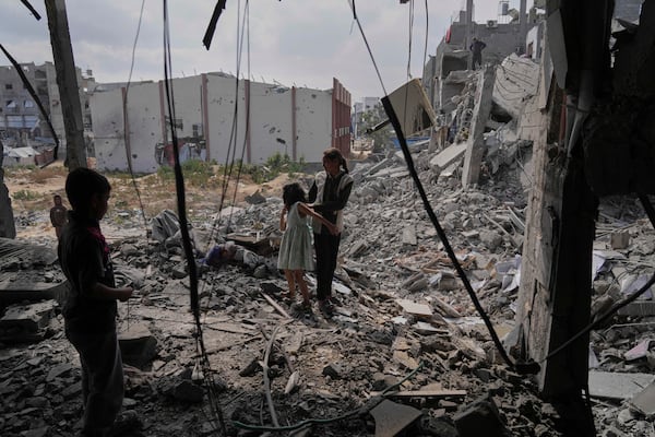 Palestinians look at the damage after an Israeli army airstrike in Beit Lahia, northern Gaza Strip, Monday, April 28, 2025. (AP Photo/Jehad Alshrafi)