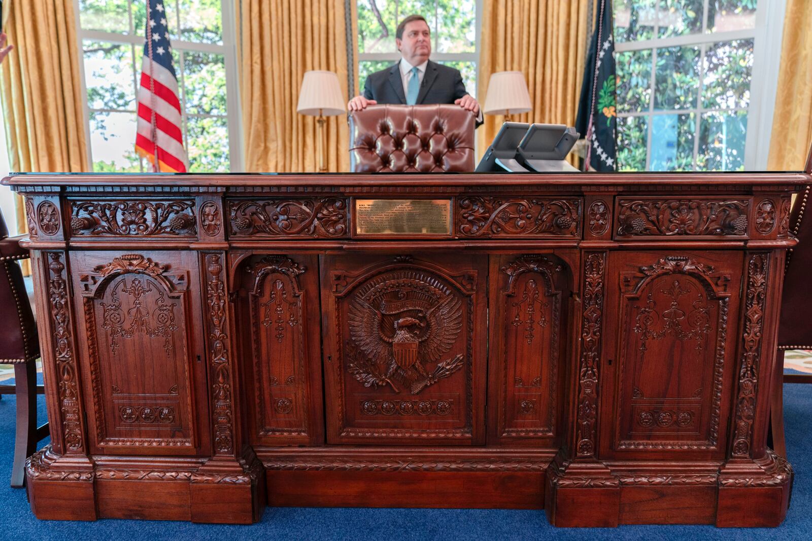 White House Historical Association President Stewart McLaurin tours members of the media in a replica of the Oval Office as is today, shown at The People's House exhibit, Monday, Sept. 16, 2024 in Washington. (AP Photo/Jose Luis Magana)