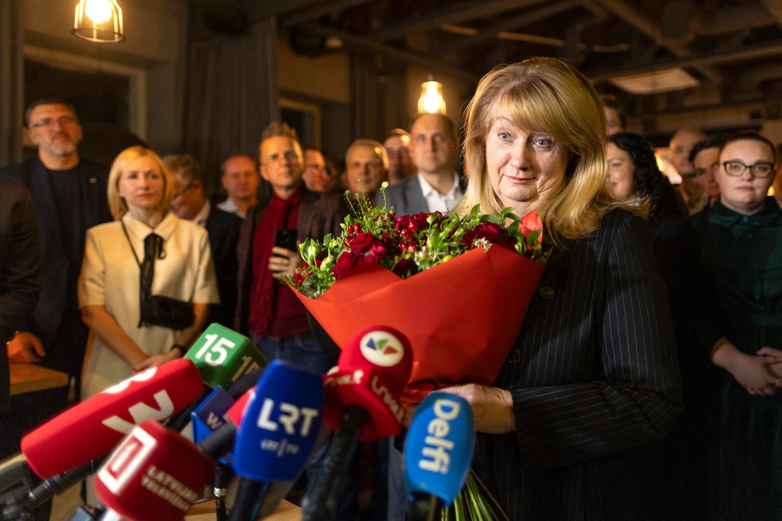 Leader of the Social Democratic Party Vilija Blinkeviciute speaks to the media while waiting for the results of the second round of Lithuania's parliamentary election, in an office in Vilnius, Lithuania, Sunday, Oct. 27, 2024. (AP Photo/Mindaugas Kulbis)