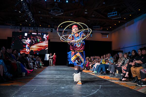 Kevin Dakota Duncan, of Phoenix, performs a hoop dance before models take to the runway at the 2025 Native Fashion Show, Friday, May 9, 2025, in Santa Fe, N.M. (AP Photo/Roberto E. Rosales)