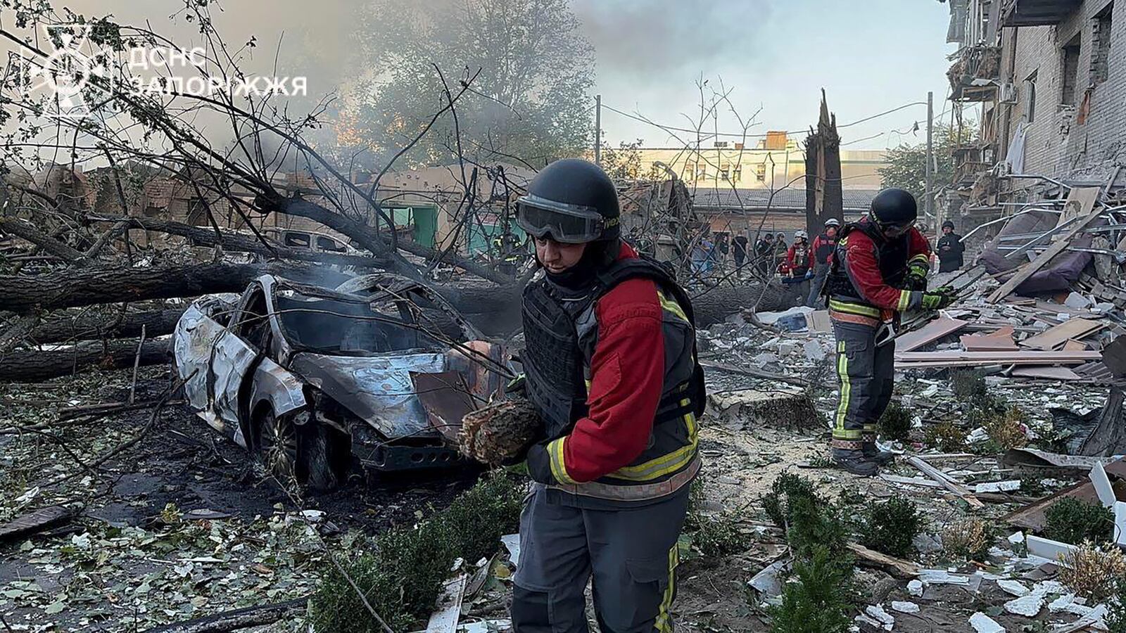 In this photo provided by the Ukrainian Emergency Service, emergency workers clear the rubble after Russia attacked the city with guided bombs overnight in Zaporizhzhia, Ukraine, Sunday, Sept. 29, 2024. (Ukrainian Emergency Service via AP)