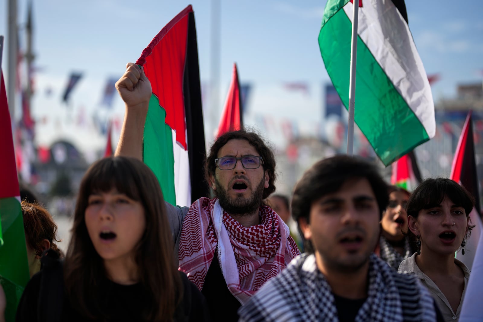 Demonstrators hold Palestinian flags and chant slogans during a pro Palestinian protest in Istanbul, Turkey, Saturday, Oct. 5, 2024. (AP Photo/Khalil Hamra)