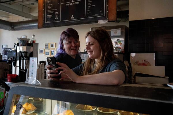 Renee Colon, co-owner of Fuego Coffee Roasters, talks to Claire Terrelli, an employee, Saturday, March 22, 2025, in Rochester, N.Y. (Max Conway via AP)