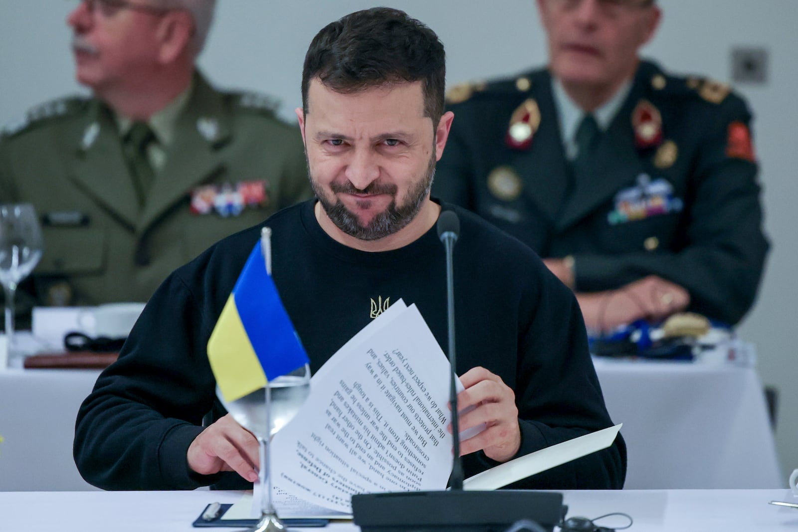 Ukraine's President Volodymyr Zelenskyy looks over his papers during the NATO-Ukraine Council working dinner at NATO Headquarters in Brussels, Thursday, Oct. 17, 2024. (Olivier Matthys, Pool Photo via AP)