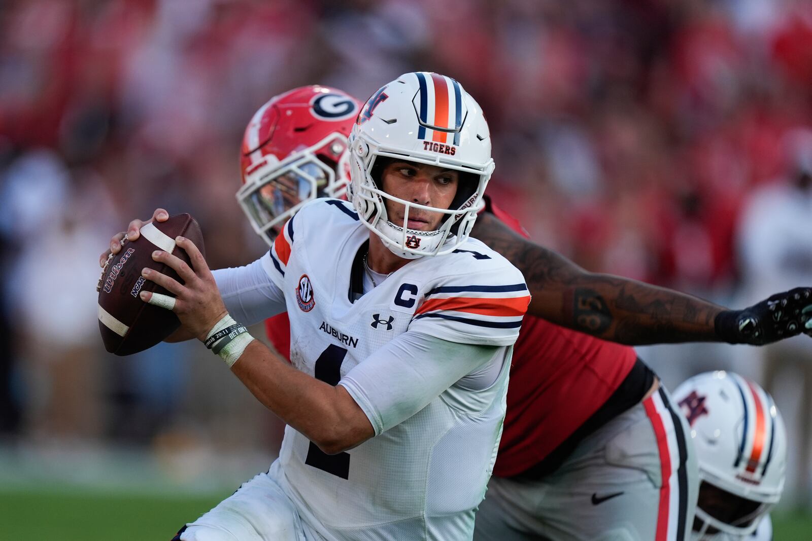 Auburn quarterback Payton Thorne (1) tries to elude a Georgia defender in the second half of an NCAA college football game Saturday, Oct. 5, 2024, in Athens, Ga. (AP Photo/John Bazemore)