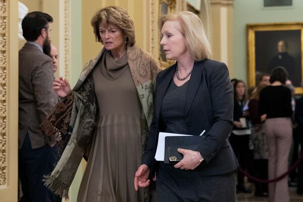 FILE - Sen. Lisa Murkowski, R-Alaska, left, walks with Sen. Kirsten Gillibrand, D-N.Y., to the Senate chamber at the Capitol, Jan. 22, 2020, in Washington. (AP Photo/Steve Helber, File)