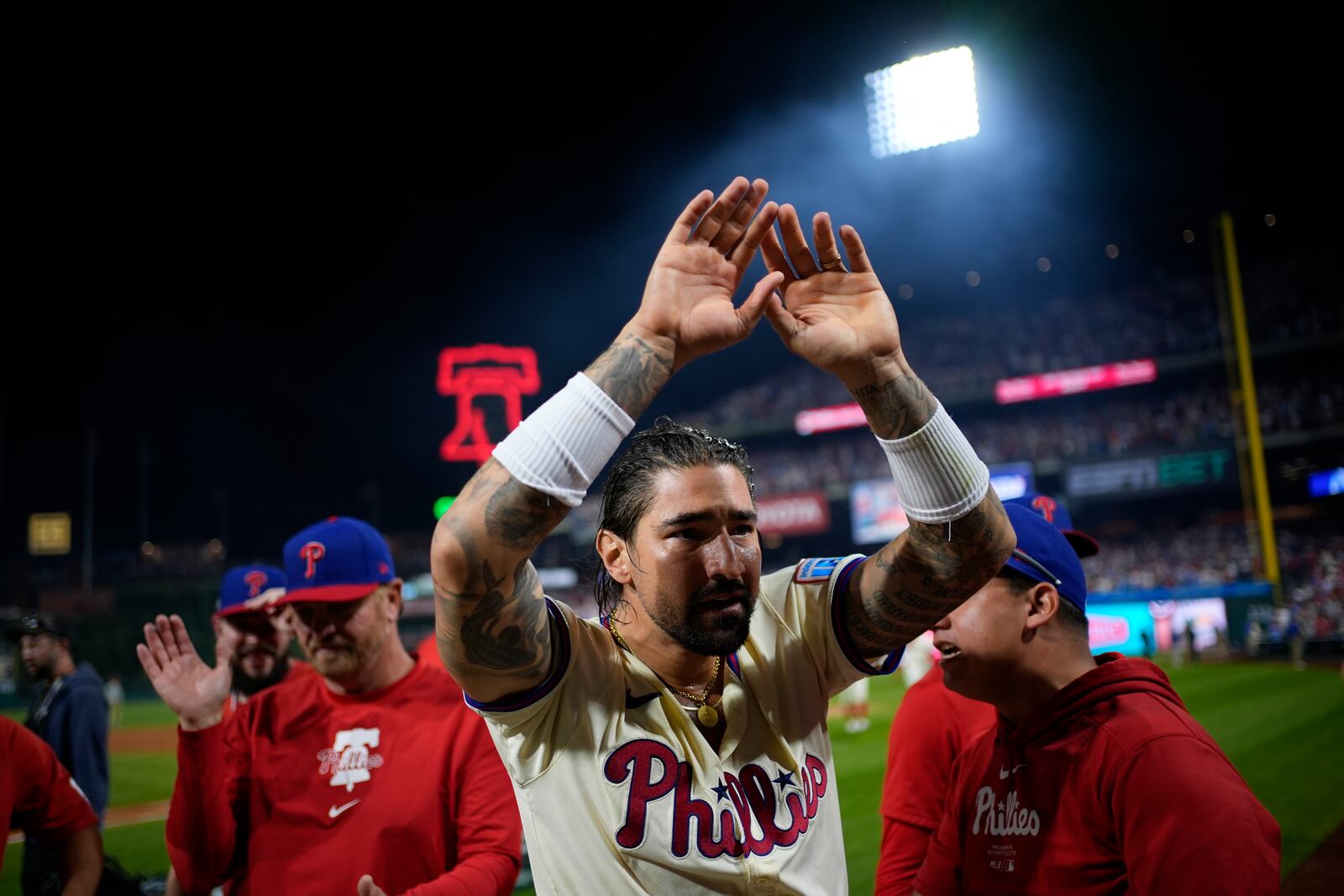 Philadelphia Phillies' Nick Castellanos celebrates his one-run single against New York Mets pitcher Tylor Megill during the ninth inning to win Game 2 of a baseball NL Division Series, Sunday, Oct. 6, 2024, in Philadelphia. (AP Photo/Matt Slocum)