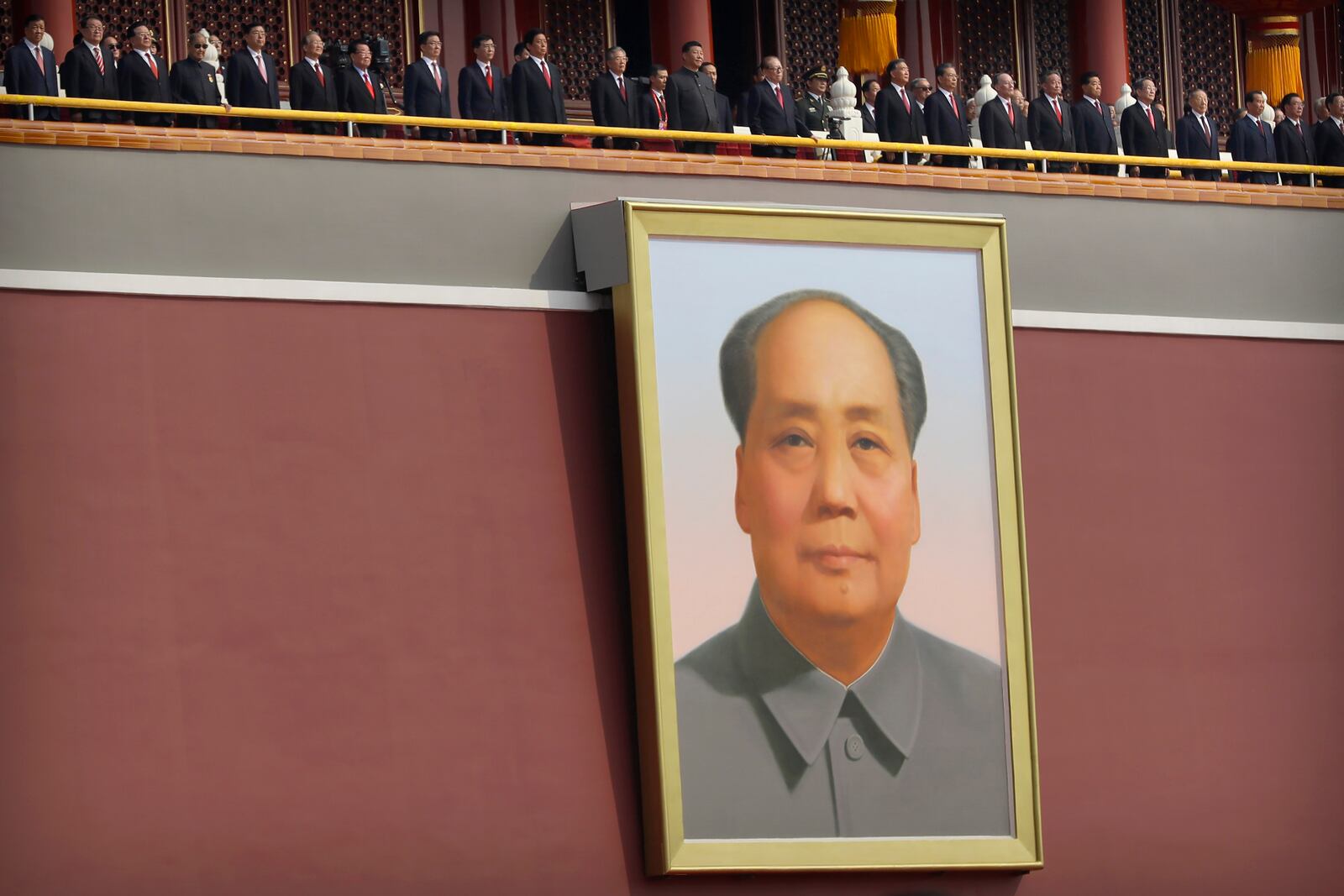 FILE - Chinese leaders including Chinese President Xi Jinping, center, stand on Tiananmen Gate above the large portrait of Chinese leader Mao Zedong during a parade to commemorate the 70th anniversary of the founding of Communist China in Beijing, Tuesday, Oct. 1, 2019. (AP Photo/Mark Schiefelbein, File)