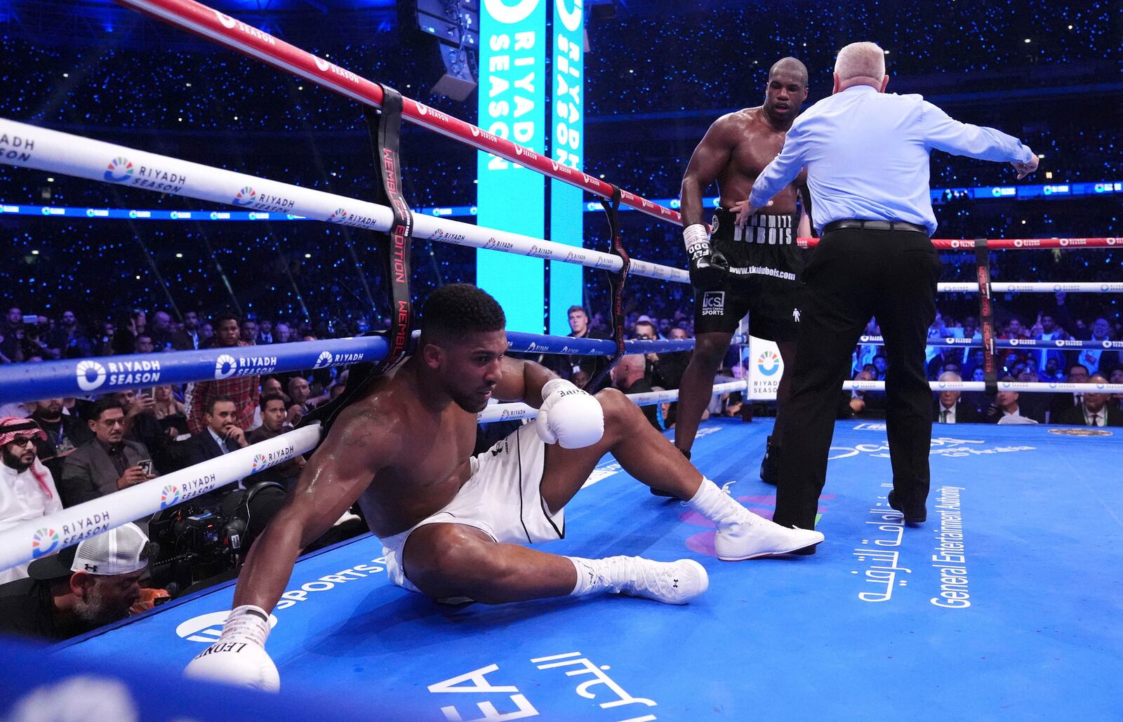 Anthony Joshua, left, knocked down by Daniel Dubois in the IBF World Heavyweight bout at Wembley Stadium, in London, Saturday, Sept. 21, 2024. (Bradley Collyer/PA via AP)