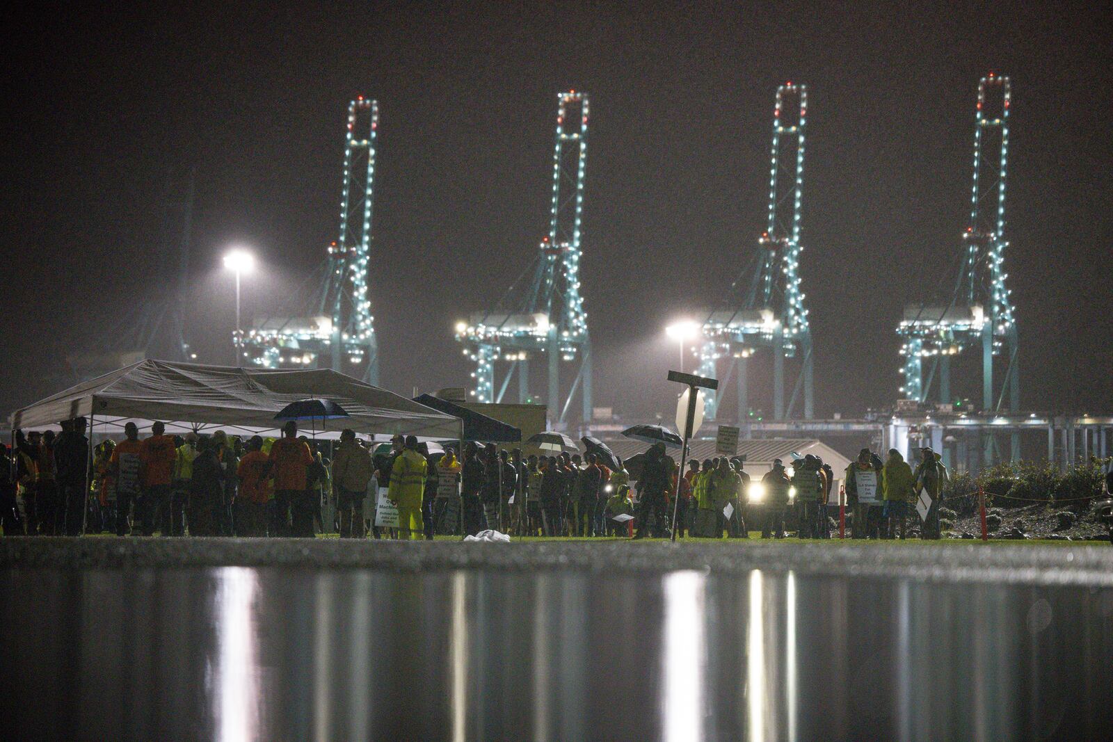 Hundreds of longshoremen strike together outside of the Virginia International Gateway in Portsmouth, Va., Tuesday, Oct. 1, 2024. (Billy Schuerman/The Virginian-Pilot via AP)