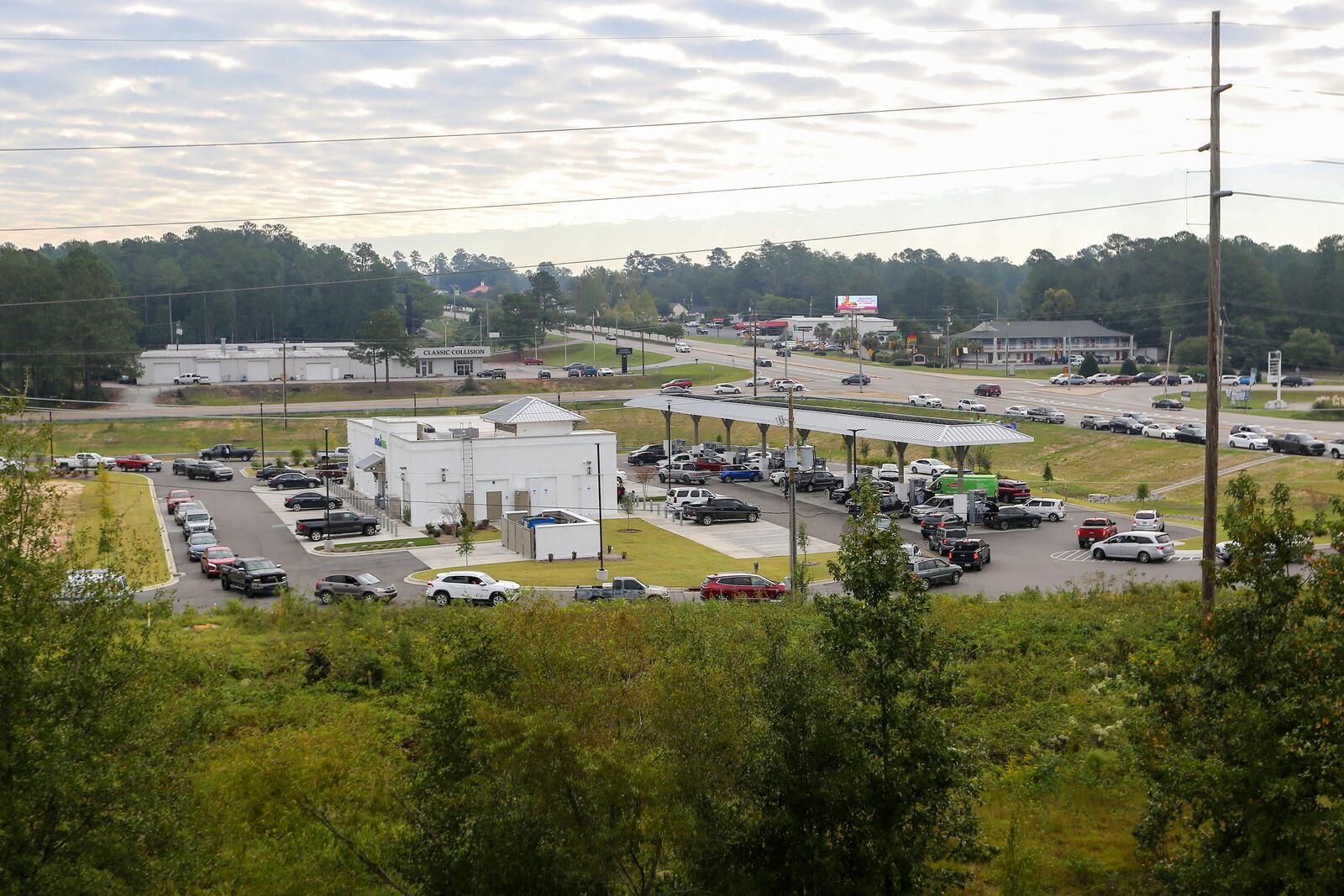 Residents wait in long lines for gas at Parker's Kitchen in the aftermath of Hurricane Helene Sunday, Sept. 29, 2024, in Aiken, S.C. (AP Photo/Artie Walker Jr.)