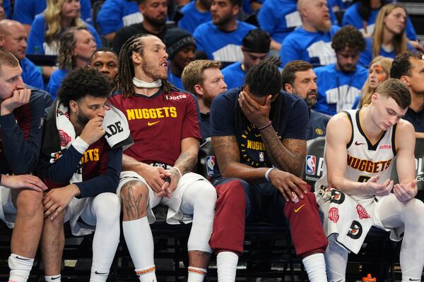 Denver Nuggets' Nikola Jokic, from left, Jamal Murray, Aaron Gordon, DeAndre Jordan and Christian Braun, right, sit on the bench watching play against the Oklahoma City Thunder late in the second half of Game 7 in the Western Conference semifinals of the NBA basketball playoffs, Sunday, May 18, 2025, in Oklahoma City. (AP Photo/Kyle Phillips)