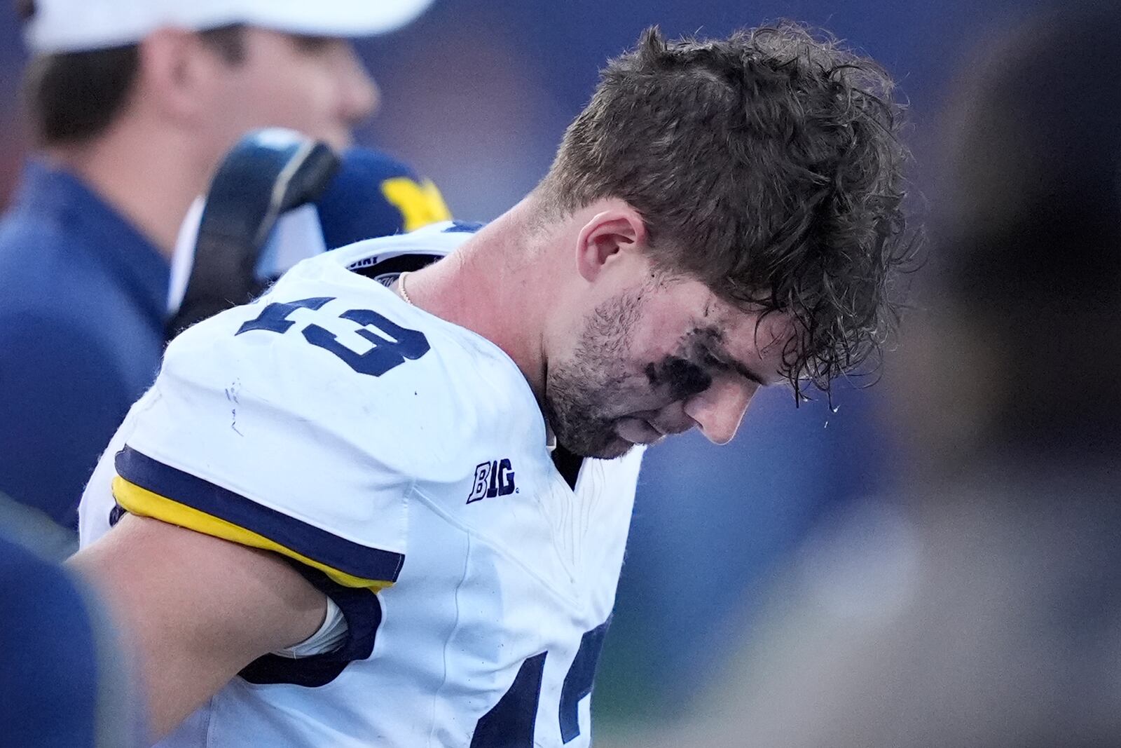 Michigan quarterback Jack Tuttle stands on the sidelines in the closing minutes of the team's 21-7 loss to Illinois in an NCAA college football game Saturday, Oct. 19, 2024, in Champaign, Ill. (AP Photo/Charles Rex Arbogast)