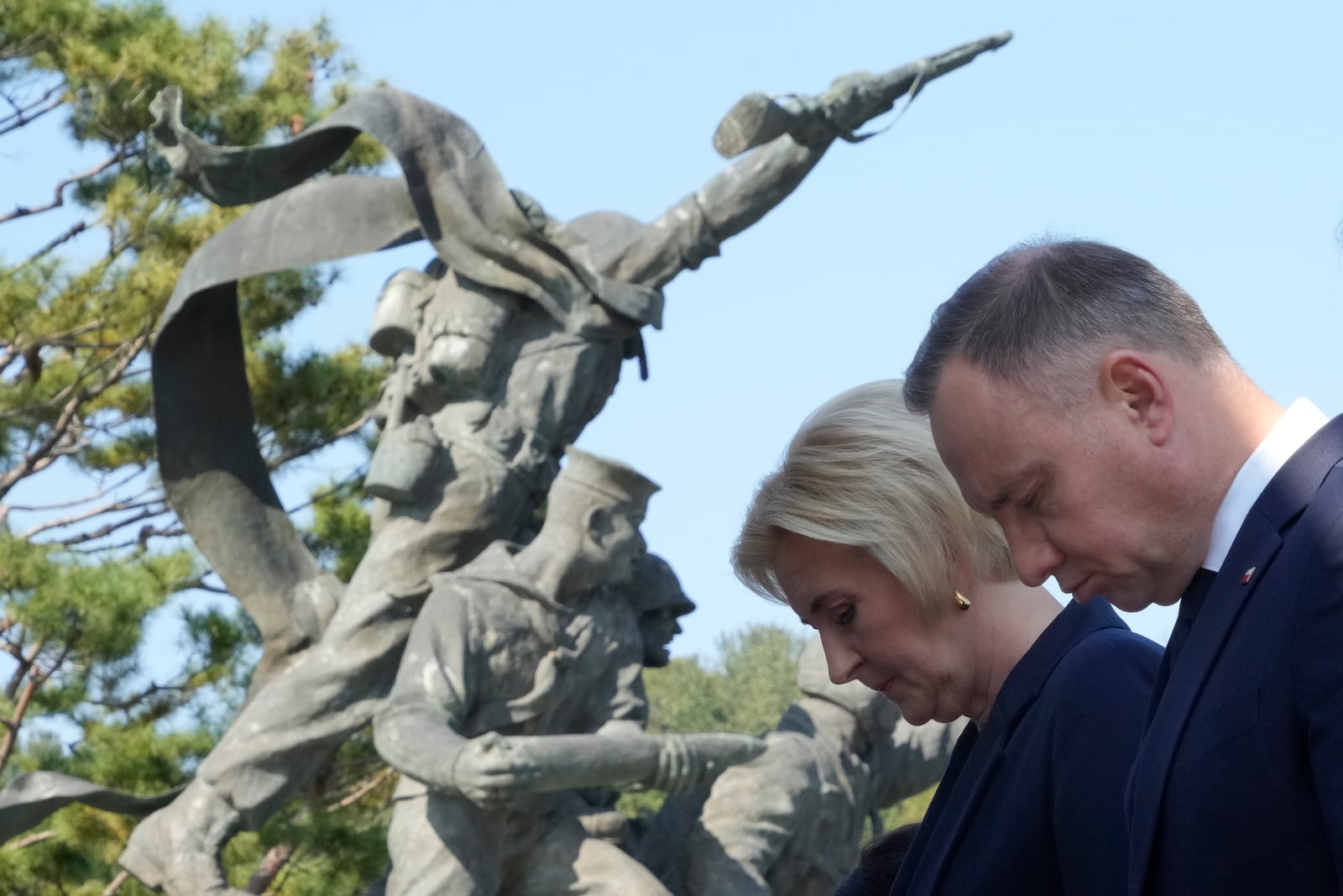 Polish President Andrzej Duda, right, and his wife Agata Kornhauser-Duda pay a silent tribute at the National Cemetery in Seoul, South Korea, Thursday, Oct. 24, 2024. (AP Photo/Ahn Young-joon)