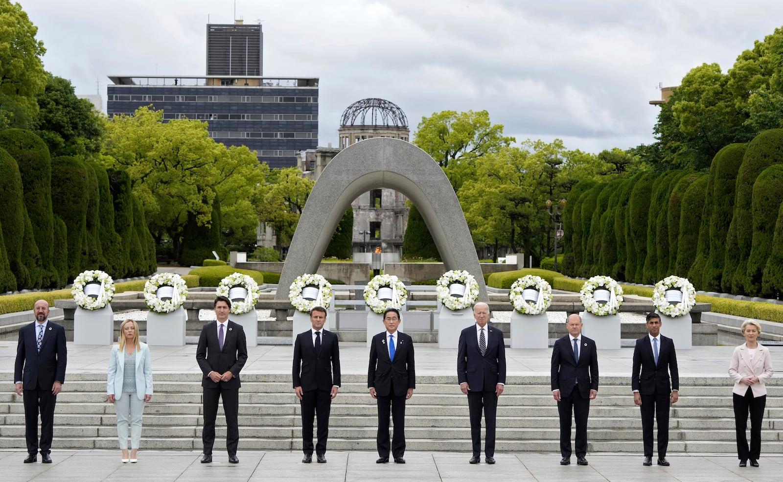 FILE - From left to right, European Council President Charles Michel, Italian Prime Minister Giorgia Meloni, Canadian Prime Minister Justin Trudeau, French President Emmanuel Macron, Japan's Prime Minister Fumio Kishida, U.S. President Joe Biden, German Chancellor Olaf Scholz, British Prime Minister Rishi Sunak, European Commission President Ursula von der Leyen pose for a group photo after laying flower wreaths at the cenotaph for Atomic Bomb Victims in the Peace Memorial Park as part of the G7 Hiroshima Summit in Hiroshima, Japan, on May 19, 2023. (Franck Robichon/Pool Photo via AP, File)