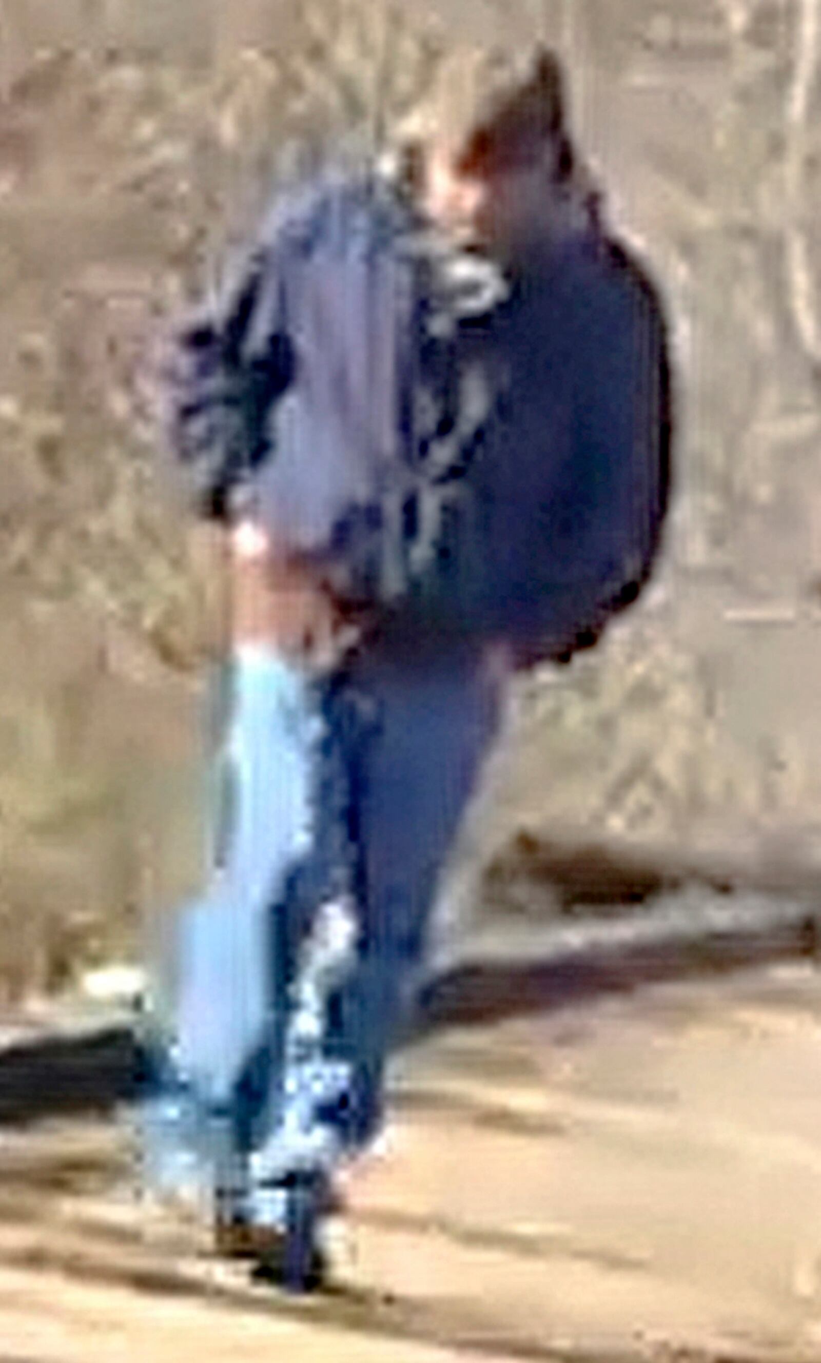 FILE - This photo released by the Indiana State Police, Feb. 13, 2017, shows a man walking along the trail system in Delphi, Ind., that authorities say is a suspect in the killings of two teenage girls. (Indiana State Police via AP, File)