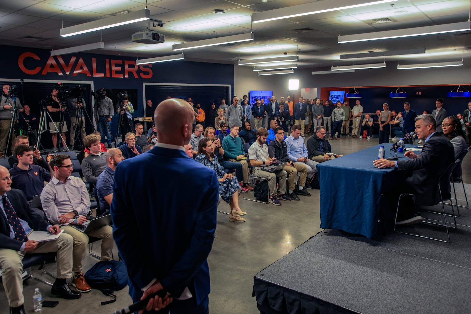 Virginia NCAA college basketball coach Tony Bennett announces his retirement, as athletic director Carla Willliams, on Bennett's right, looks on during a press conference in Charlottesville, Va., Friday, Oct. 18, 2024. (Cal Cary/The Daily Progress via AP)