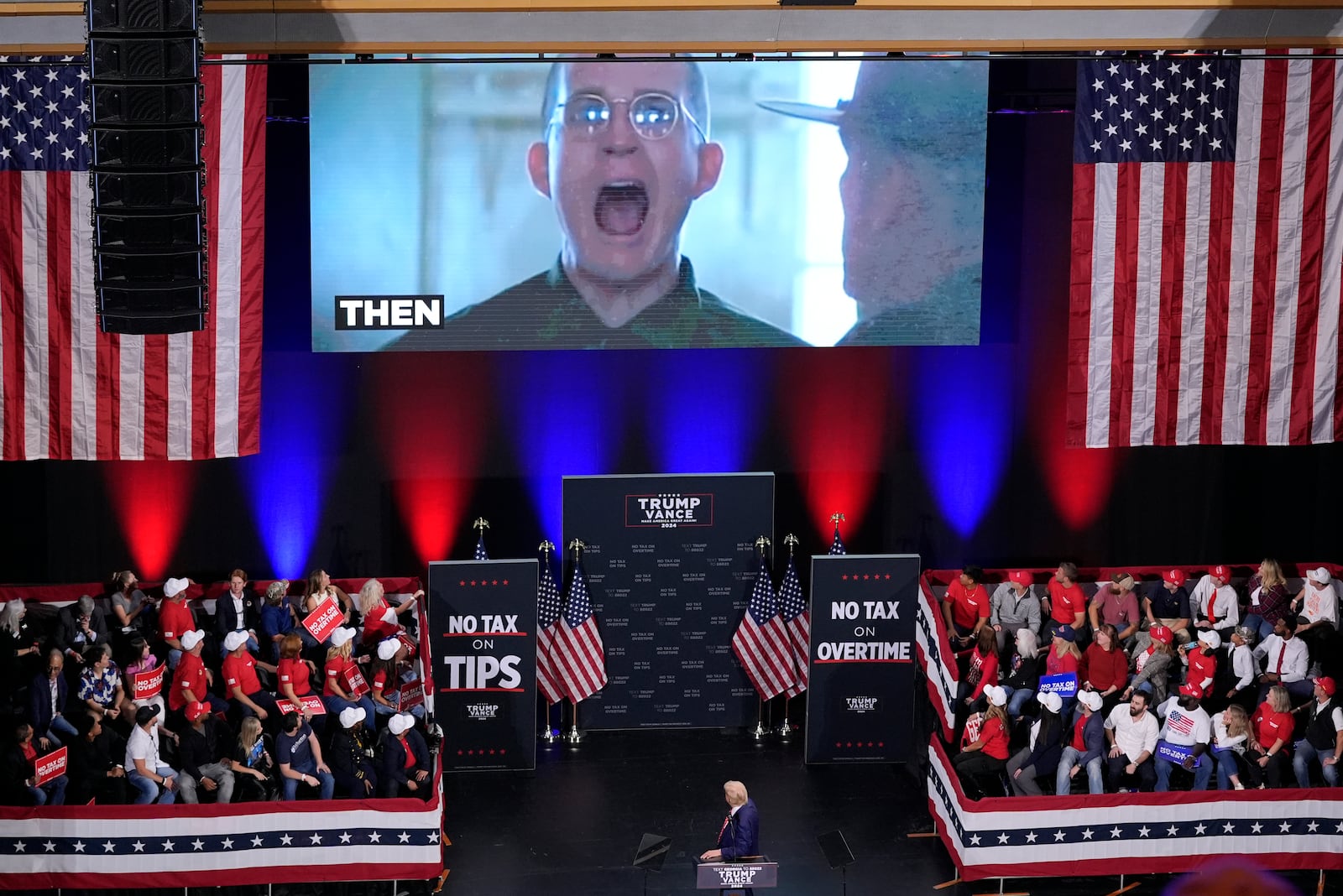 Republican presidential nominee former President Donald Trump watches as a video plays as he speaks at a campaign event at the Cobb Energy Performing Arts Centre, Tuesday, Oct. 15, 2024, in Atlanta. (AP Photo/Alex Brandon)