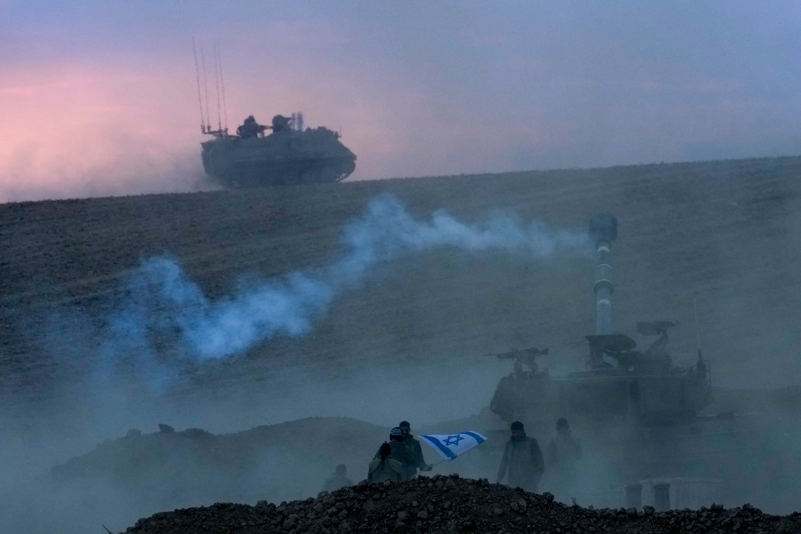 An Israeli mobile artillery unit fires a shell from southern Israel toward the Gaza Strip, in a position near the Israel-Gaza border, Israel, Saturday, Oct. 14, 2023. (AP Photo/Maya Alerruzzo)