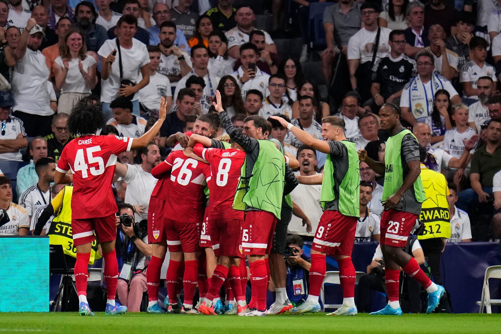 Stuttgart players celebrate their side's first goal during the Champions League opening phase soccer match between Real Madrid and VfB Stuttgart at the Santiago Bernabeu stadium, in Madrid, Tuesday, Sept. 17, 2024. (AP Photo/Manu Fernandez)